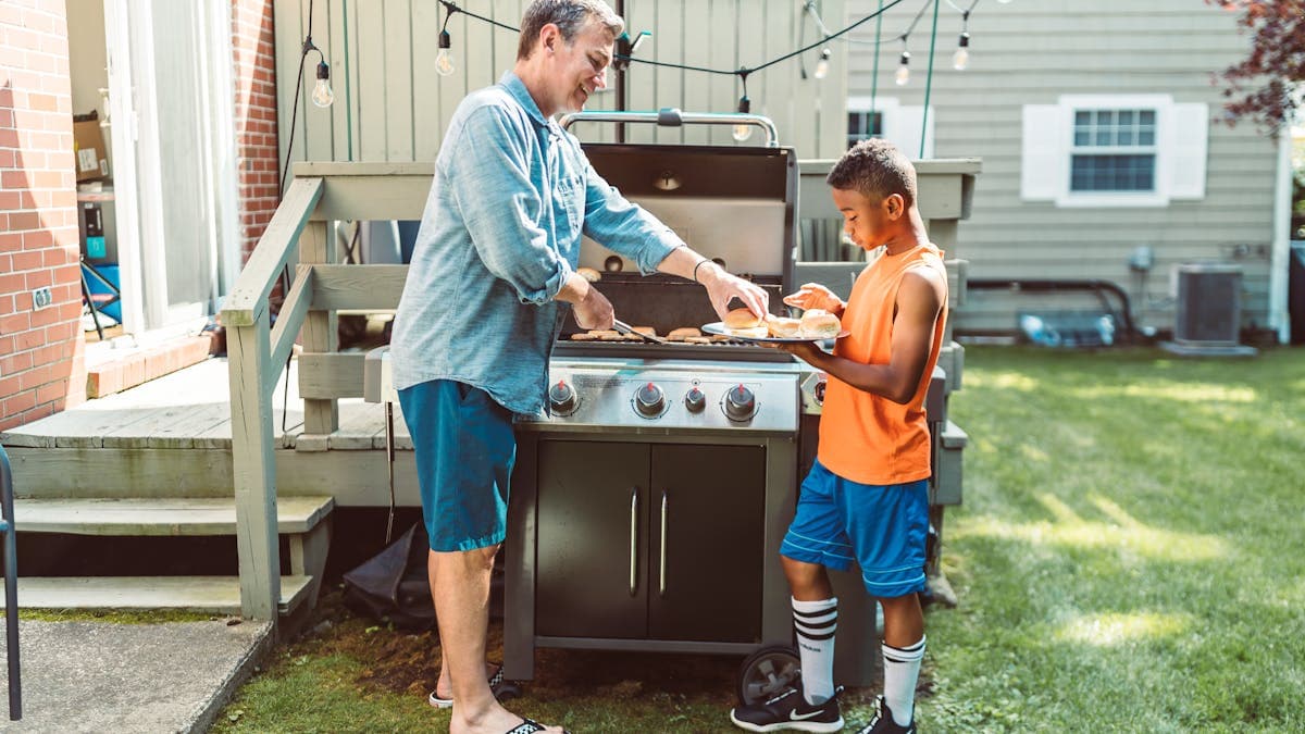 Father and son grilling in the backyard